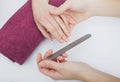 Woman hands in a nail salon receiving a manicure procedure. SPA Royalty Free Stock Photo