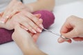 Woman hands in a nail salon receiving a manicure procedure. SPA Royalty Free Stock Photo