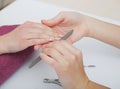 Woman hands in a nail salon receiving a manicure procedure. SPA Royalty Free Stock Photo