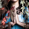 Closeup woman hands in namaste gesture outdoor shot