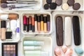 Woman hands neatly placing cosmetic and vanity items in MUJI's PP makeup storage boxes.