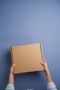 Woman hands open empty cardboard box, top view Royalty Free Stock Photo