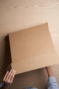 Woman hands open empty cardboard box, top view Royalty Free Stock Photo