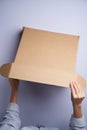 Woman hands open empty cardboard box, top view Royalty Free Stock Photo