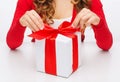 Woman hands opening gift boxes