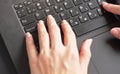 Woman hands over black laptop keyboard, closeup detail from above Royalty Free Stock Photo