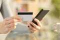 Woman hands paying with credit card on phone Royalty Free Stock Photo