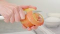 Woman hands peeling red apple. Close-up view, apple cake recipe, ingredients for the cake close-up on a kitchen table