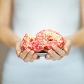 Woman hands with perfect nail polish holding a plate with pink donuts Royalty Free Stock Photo