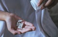 Woman hands with pills on spilling pills out of bottle,Female hand holding a medicine Royalty Free Stock Photo