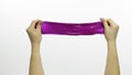 Woman hands playing oddly satisfying purple slime. White background. Antistress Royalty Free Stock Photo