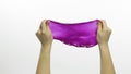 Woman hands playing oddly satisfying purple slime. White background. Antistress Royalty Free Stock Photo