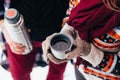 Woman hands pours hot tea or coffee out of thermos on winter forest background. girl using a thermos in on a snowy day. metallic c Royalty Free Stock Photo