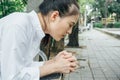 Woman hands praying with a bible in her knees outdoors