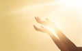 Woman hands praying for blessing from god on sunset background Royalty Free Stock Photo