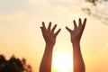 Woman hands praying for blessing on sunset background Royalty Free Stock Photo