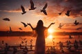 Woman praying and free bird enjoying nature on sunset background, hope concept Royalty Free Stock Photo