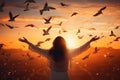 Woman praying and free bird enjoying nature on sunset background, hope concept Royalty Free Stock Photo