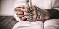 Woman hands praying with rosary and bible