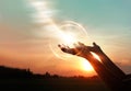 Woman hands praying on sunset background