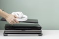 Woman hands put laptop computer and headphones on pile of old used laptop computers for recycling on white table Royalty Free Stock Photo