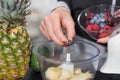 Bursting with Blueberries: Woman Prepares a Healthy Fruit Smoothie Royalty Free Stock Photo