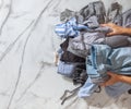 Woman hands putting stack of clean clothes for neatly tidying up and placing in steel wire wardrobe