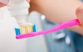 Woman hands putting toothpaste on toothbrush Royalty Free Stock Photo