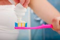 Woman hands putting toothpaste on toothbrush Royalty Free Stock Photo