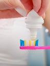 Woman hands putting toothpaste on toothbrush Royalty Free Stock Photo