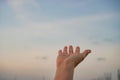 Woman hands reach out to the sky like praying in front of sky. Royalty Free Stock Photo