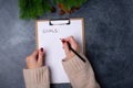 Woman hands ready to write goals on blank list on dark background. Flat lay. Top view. New year concept. Target success Royalty Free Stock Photo