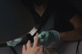 Woman hands receiving a manicure in beauty salon. Nail filing. Close up, selective focus Royalty Free Stock Photo