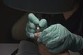 Woman hands receiving a manicure in beauty salon. Nail filing. Close up, selective focus Royalty Free Stock Photo