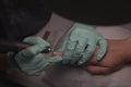 Woman hands receiving a manicure in beauty salon. Nail filing. Close up, selective focus Royalty Free Stock Photo