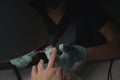 Woman hands receiving a manicure in beauty salon. Nail filing. Close up, selective focus Royalty Free Stock Photo