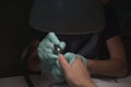 Woman hands receiving a manicure in beauty salon. Nail filing. Close up, selective focus Royalty Free Stock Photo