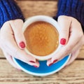 Woman hands with red manicure and cup of coffee Royalty Free Stock Photo