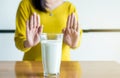 Woman hands refusing a glass of milk,Female having allergy milk,Lactose intolerance concept