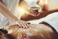 Woman, hands and relax in salt scrub for skincare, exfoliation or relaxation at indoor beauty spa. Hand of masseuse