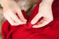 Woman hands sewing a button