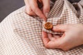 Woman Hands sewing button on fabric Royalty Free Stock Photo