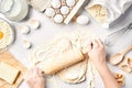 Baking preparation. Raw dough and cutters for the holiday cookies on a white table. Top view. Royalty Free Stock Photo