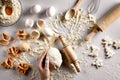 Baking preparation. Raw dough and cutters for the holiday cookies on a white table. Top view. Royalty Free Stock Photo
