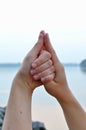 Woman hands in shell mudra against sea Royalty Free Stock Photo