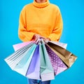 Woman, hands and shopping bags for purchase, sale or luxury accessories against a blue studio background. Hand of female Royalty Free Stock Photo