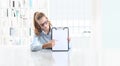 Woman hands showing clipboard with a pen, sitting in office Royalty Free Stock Photo