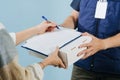 Woman hands, signing a paper form, offered by a courier. Royalty Free Stock Photo