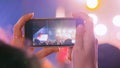 Woman hands silhouette recording video of live music concert with smartphone Royalty Free Stock Photo
