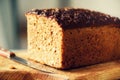 Woman hands slicing freshly backed bread. Handmade brown loaf of bread, bakery concept, homemade food, healthy eating Royalty Free Stock Photo